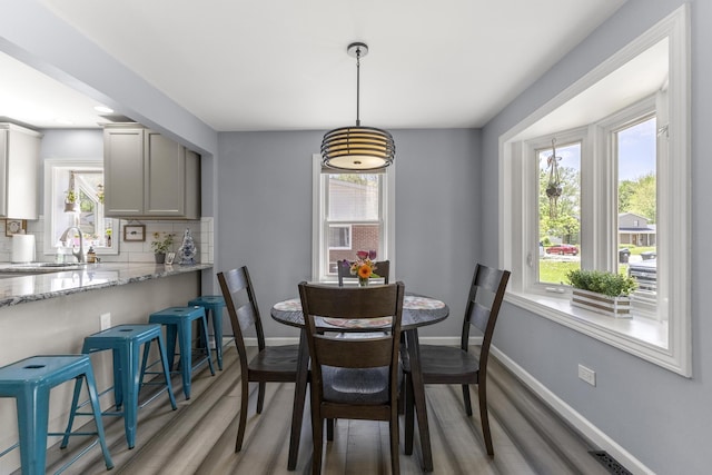 22171 Monterey Dr, Trenton, MI 48183 - dining space with light wood-style floors, healthy amount of natural light, and baseboards