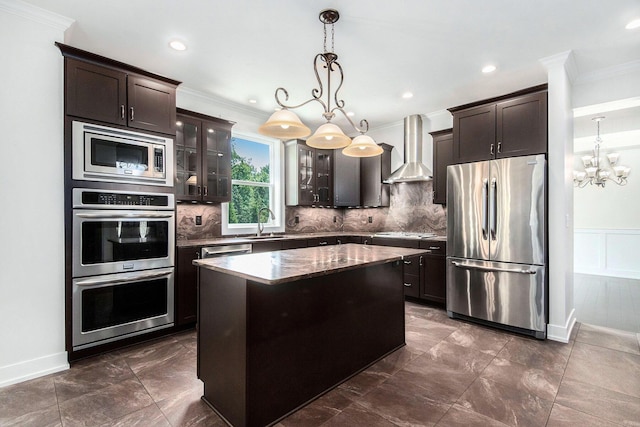 8030 Lionel Dr SW, Byron Center, MI 49315 - kitchen featuring appliances with stainless steel finishes, wall chimney range hood, ornamental molding, dark brown cabinetry, and a chandelier