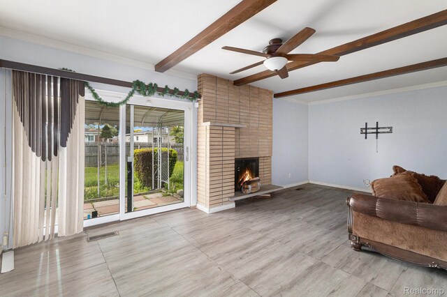 11414 Nancy Dr, Warren, MI 48093 - living room featuring beamed ceiling, a ceiling fan, a brick fireplace, baseboards, and ornamental molding