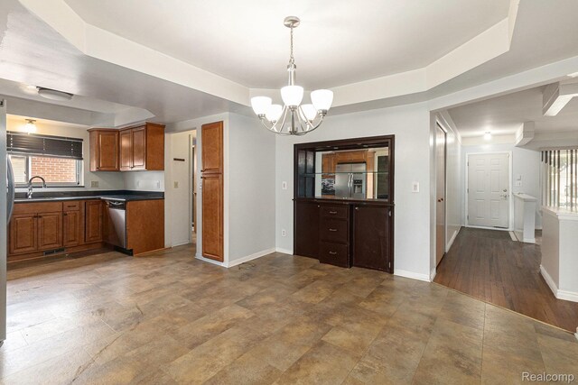 11414 Nancy Dr, Warren, MI 48093 - kitchen with a sink, a chandelier, brown cabinetry, dark countertops, and a raised ceiling