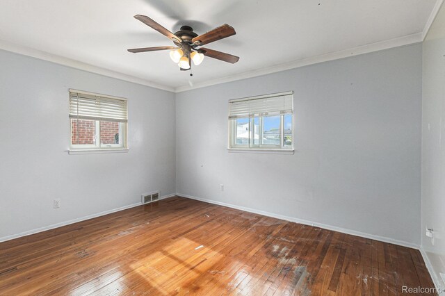 11414 Nancy Dr, Warren, MI 48093 - spare room with healthy amount of natural light, ceiling fan, ornamental molding, hardwood / wood-style flooring, and baseboards