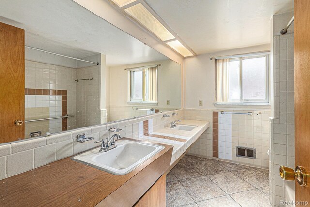 11414 Nancy Dr, Warren, MI 48093 - full bathroom featuring tile patterned floors, tile walls, a shower, vanity, and decorative backsplash
