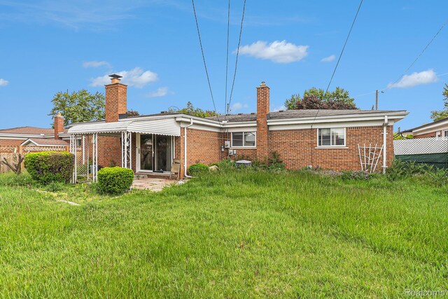 11414 Nancy Dr, Warren, MI 48093 - back of property featuring a chimney and brick siding