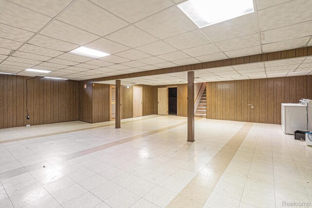 11414 Nancy Dr, Warren, MI 48093 - finished below grade area featuring washer / dryer, a drop ceiling, wood walls, stairway, and tile patterned floors