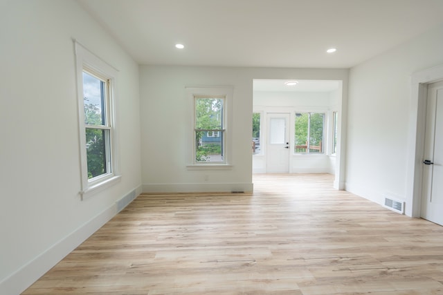 empty room featuring light wood-style floors, recessed lighting, and baseboards