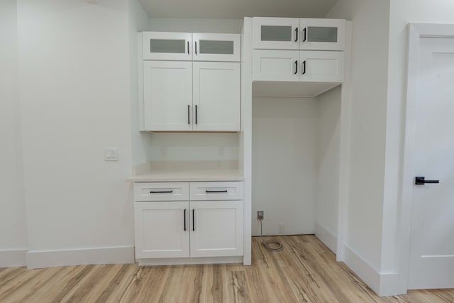 mudroom with light wood-style flooring and baseboards