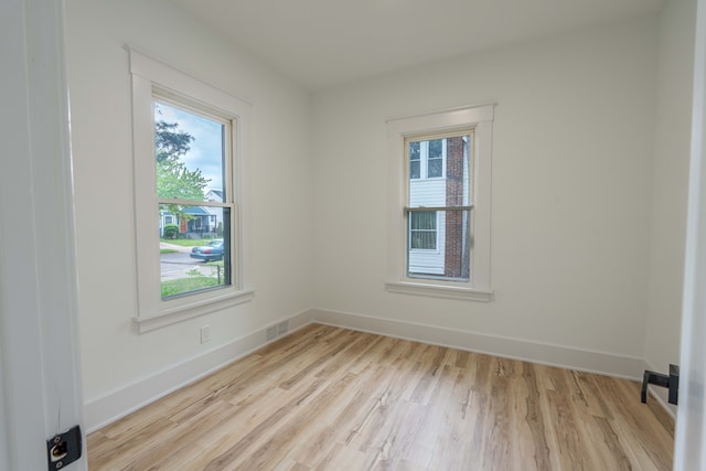 unfurnished room with wood finished floors and baseboards