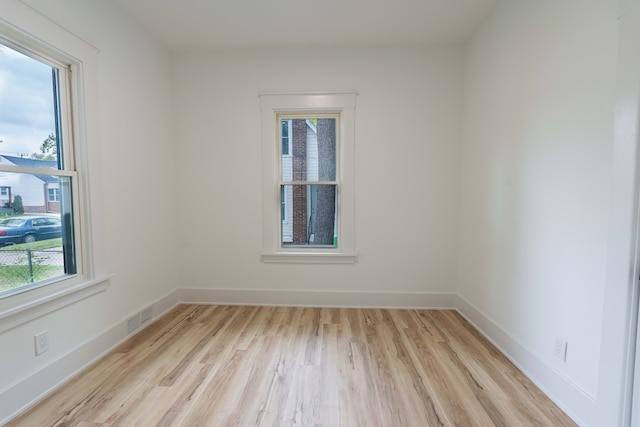 unfurnished room featuring light wood-type flooring and baseboards