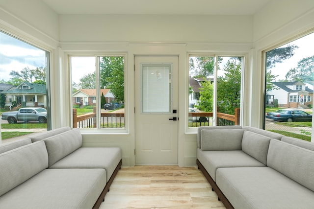 sunroom with wood finished floors and healthy amount of natural light