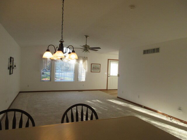 1303 Carriage Dr, Tecumseh, MI 49286 - unfurnished dining area with baseboards, a chandelier, carpet floors, and a ceiling fan