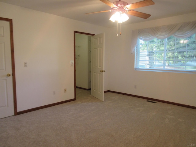 1303 Carriage Dr, Tecumseh, MI 49286 - empty room featuring ceiling fan and light colored carpet