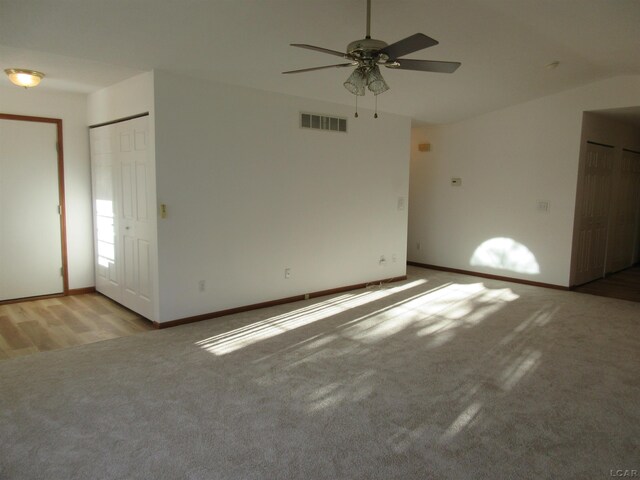1303 Carriage Dr, Tecumseh, MI 49286 - unfurnished room featuring light carpet, a ceiling fan, baseboards, and vaulted ceiling