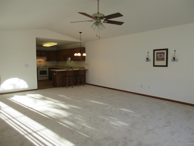 1303 Carriage Dr, Tecumseh, MI 49286 - unfurnished living room featuring lofted ceiling, light carpet, ceiling fan, a chandelier, and baseboards