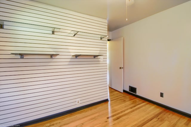 unfurnished bedroom featuring wood finished floors and baseboards