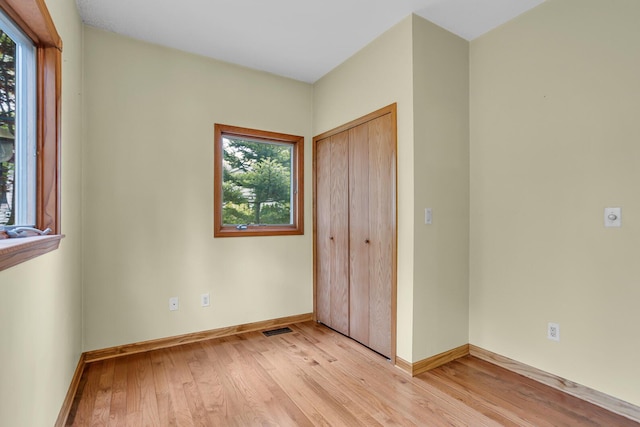 186 Goldsmith Dr, Clarklake, MI 49234 - unfurnished bedroom with light wood-style floors, baseboards, and a closet