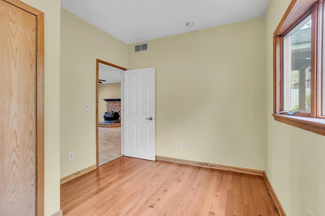 186 Goldsmith Dr, Clarklake, MI 49234 - unfurnished bedroom with multiple windows, light wood-type flooring, and baseboards