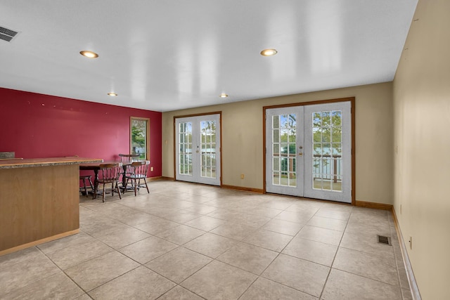 186 Goldsmith Dr, Clarklake, MI 49234 - dining room featuring french doors, recessed lighting, a bar, light tile patterned floors, and baseboards