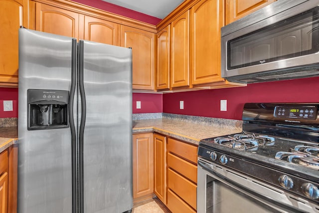 186 Goldsmith Dr, Clarklake, MI 49234 - kitchen with stainless steel appliances and brown cabinetry