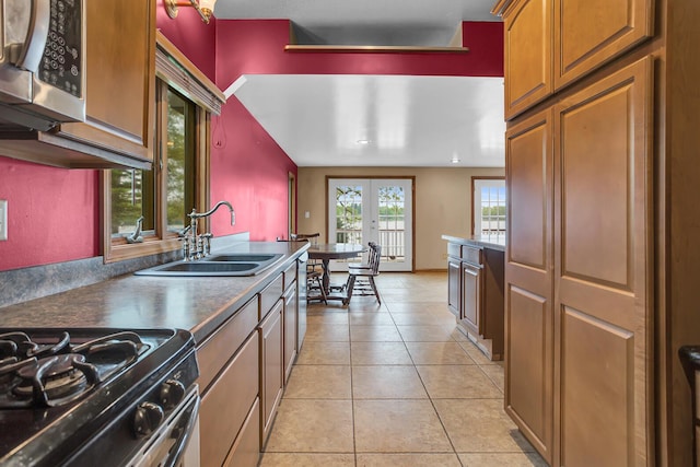 186 Goldsmith Dr, Clarklake, MI 49234 - kitchen featuring stainless steel microwave, a sink, range with gas stovetop, french doors, and brown cabinets