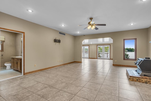 186 Goldsmith Dr, Clarklake, MI 49234 - unfurnished living room featuring light tile patterned floors, ceiling fan, recessed lighting, baseboards, and a wood stove