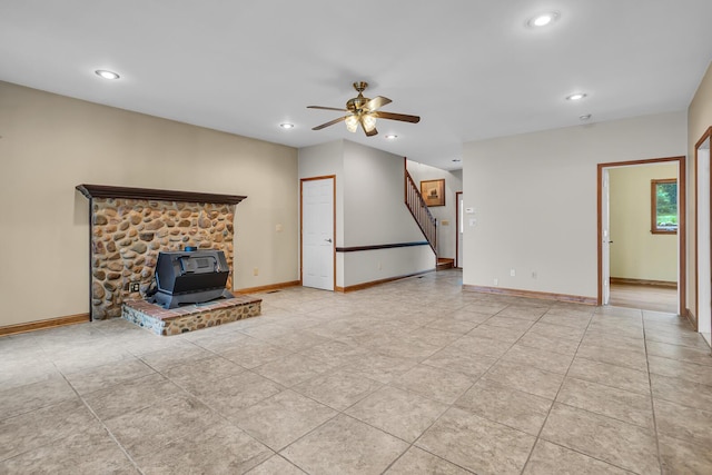 186 Goldsmith Dr, Clarklake, MI 49234 - unfurnished living room featuring a wood stove, a ceiling fan, stairs, recessed lighting, and baseboards