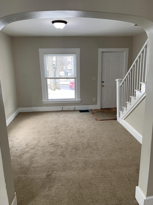 954 Adams St SE, Grand Rapids, MI 49507 - entryway with arched walkways, baseboards, carpet flooring, and stairs