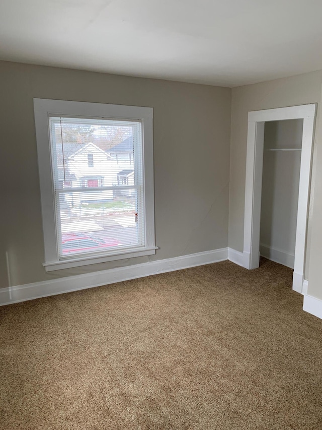 954 Adams St SE, Grand Rapids, MI 49507 - unfurnished bedroom featuring carpet, baseboards, and a closet
