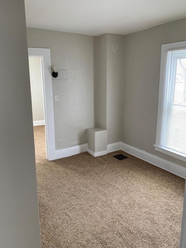 954 Adams St SE, Grand Rapids, MI 49507 - carpeted empty room with baseboards