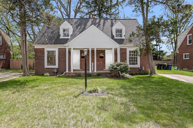 7407 Curtis St, Detroit, MI 48221 - new england style home with brick siding, a porch, and a shingled roof