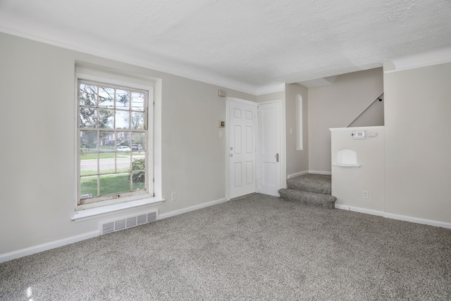 7407 Curtis St, Detroit, MI 48221 - spare room featuring carpet flooring, a textured ceiling, baseboards, and stairway