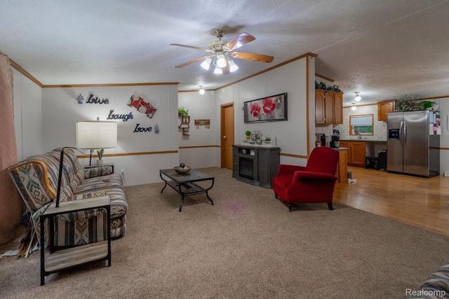 4232 Washburn Rd, Vassar, MI 48768 - living room featuring ornamental molding, light colored carpet, ceiling fan, and a textured ceiling