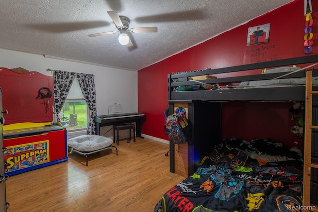 4232 Washburn Rd, Vassar, MI 48768 - bedroom featuring lofted ceiling, a textured ceiling, wood finished floors, and a ceiling fan