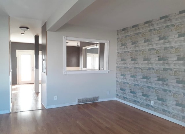 2205 Regina Ave, Lincoln Park, MI 48146 - empty room featuring wood finished floors, baseboards, and an accent wall