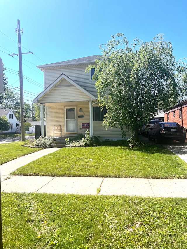 2205 Regina Ave, Lincoln Park, MI 48146 - view of front of house with a porch and a front lawn