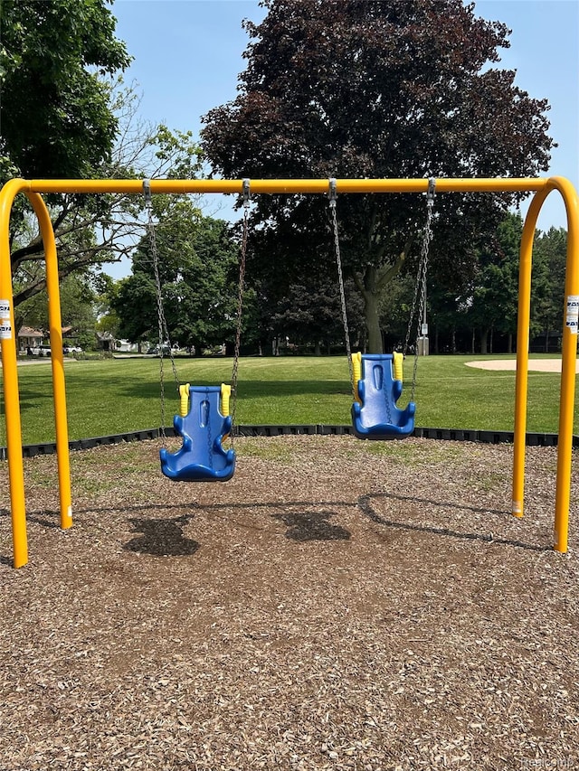 2205 Regina Ave, Lincoln Park, MI 48146 - community playground featuring a yard and view of wooded area