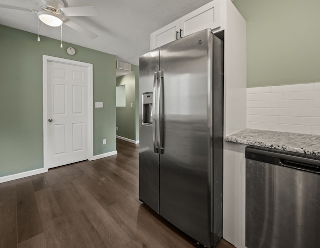 21357 Poinciana St, Southfield, MI 48033 - kitchen with stainless steel appliances, white cabinets, a ceiling fan, dark wood-style flooring, and light stone counters
