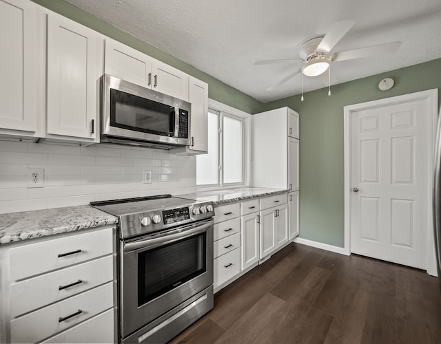 21357 Poinciana St, Southfield, MI 48033 - kitchen with stainless steel appliances, a ceiling fan, dark wood-type flooring, and white cabinets