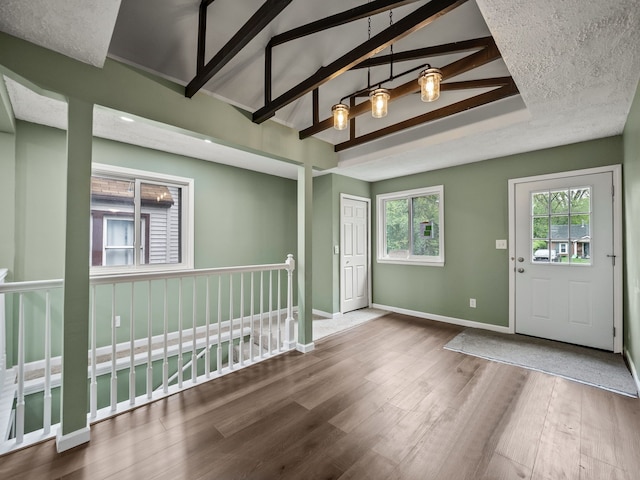 21357 Poinciana St, Southfield, MI 48033 - foyer featuring wood finished floors, baseboards, and beam ceiling