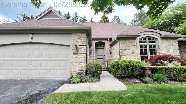 22170 Orchard Way, Beverly Hills, MI 48025 - view of front of property with a shingled roof, driveway, an attached garage, and brick siding