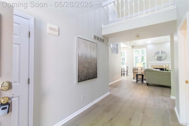 22170 Orchard Way, Beverly Hills, MI 48025 - hallway featuring wood finished floors, a towering ceiling, and baseboards