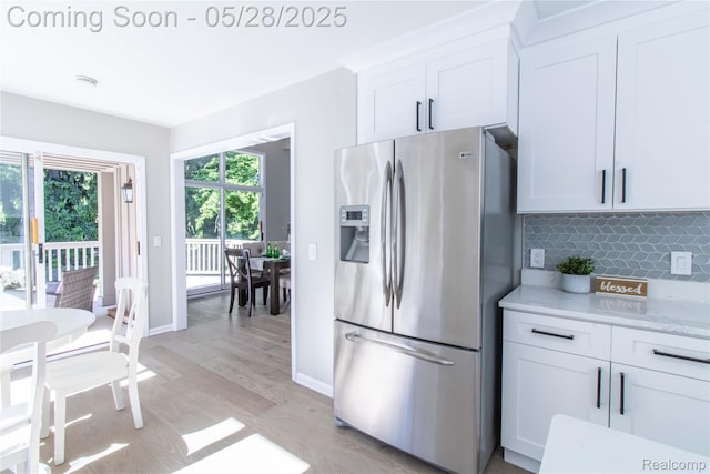 22170 Orchard Way, Beverly Hills, MI 48025 - kitchen featuring stainless steel fridge with ice dispenser, light wood-style flooring, backsplash, white cabinetry, and baseboards
