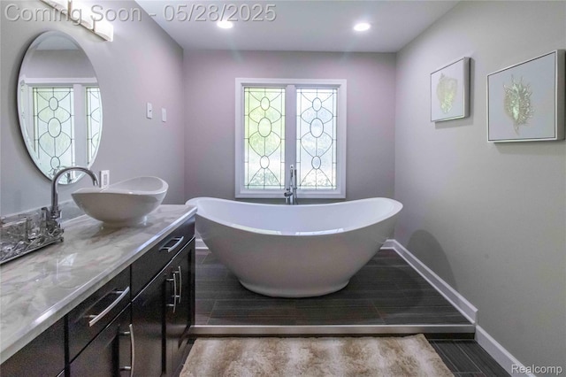 22170 Orchard Way, Beverly Hills, MI 48025 - bathroom with vanity, a freestanding tub, baseboards, and recessed lighting