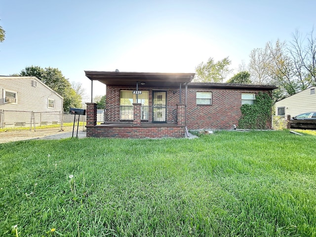 back of property featuring brick siding and covered porch