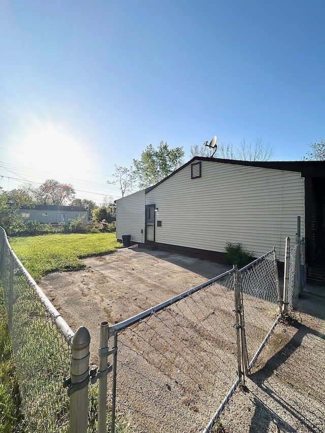 view of side of property with fence and a gate