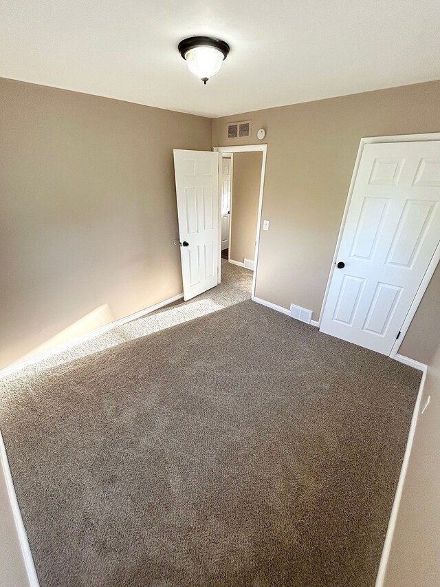 unfurnished bedroom featuring carpet and baseboards