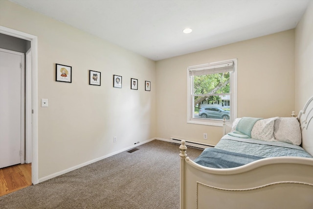 1008 Park St, Tecumseh, MI 49286 - carpeted bedroom with baseboard heating, baseboards, and recessed lighting