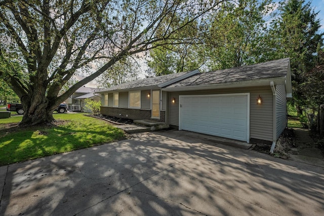 1008 Park St, Tecumseh, MI 49286 - view of front of home with driveway, a front lawn, a garage, and brick siding