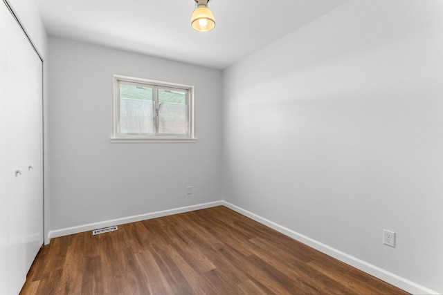 15945 Horger Ave, Allen Park, MI 48101 - unfurnished bedroom featuring a closet, dark wood-style flooring, and baseboards