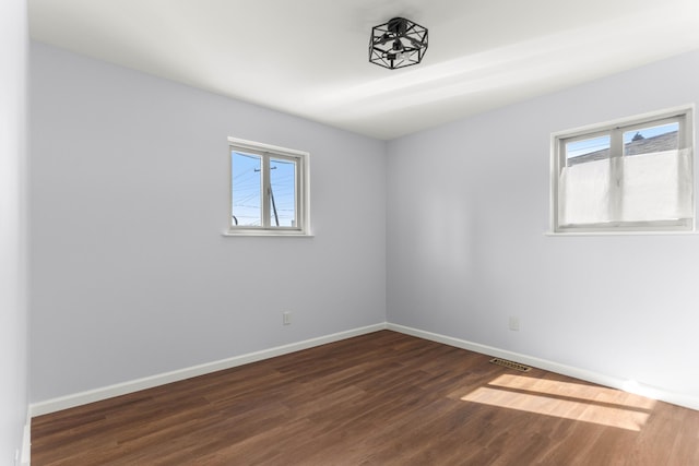 15945 Horger Ave, Allen Park, MI 48101 - empty room with healthy amount of natural light, dark wood-type flooring, and baseboards