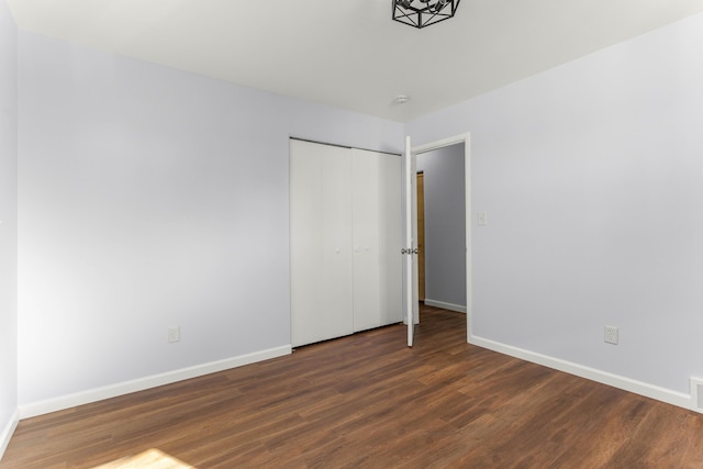 15945 Horger Ave, Allen Park, MI 48101 - unfurnished bedroom with wood finished floors, baseboards, and a closet